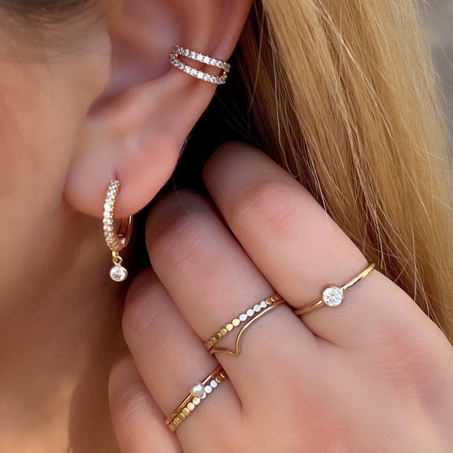 Close Up of Model Wearing Ale Weston Stacker Rings with Double Dainty CZ Pave Ear Cuff with Sparkle cz huggie hoop earrings