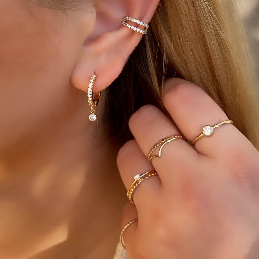 Model Wearing Ale Weston Stacker Rings with with Sparkle cz huggie hoop earrings with Double Dainty CZ Pave Ear Cuff