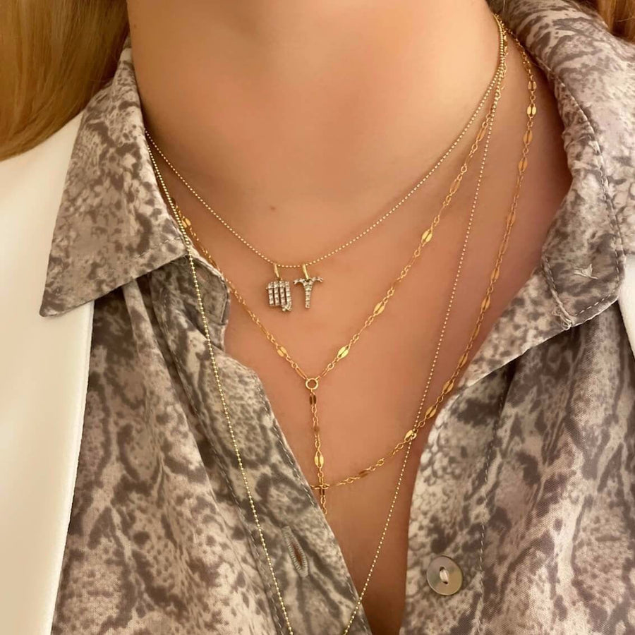 Model Wearing Ale Weston 14k Gold Design Your Own Story Charm Necklace, Aries and Virgo charms, with14k Gold Ball Chain Necklace