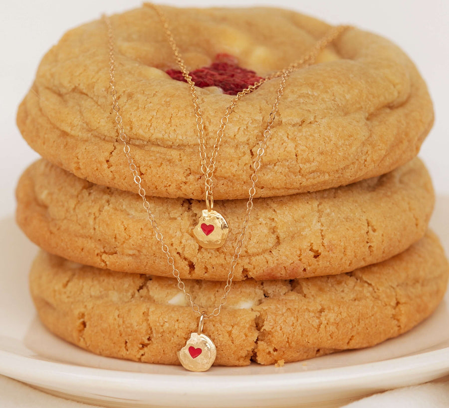 Two-White-Chocolate-Raspberry-Ale-Weston-x-Milk-Jar-Cookies-Gold-Enamel-Necklaces-layered-over-cookie