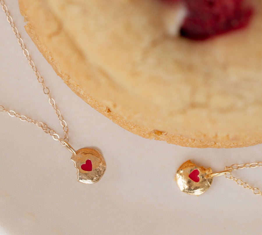 Two-White-Chocolate-Raspberry-Ale-Weston-x-Milk-Jar-Cookies-Gold-Enamel-Necklaces-layered-around-cookie